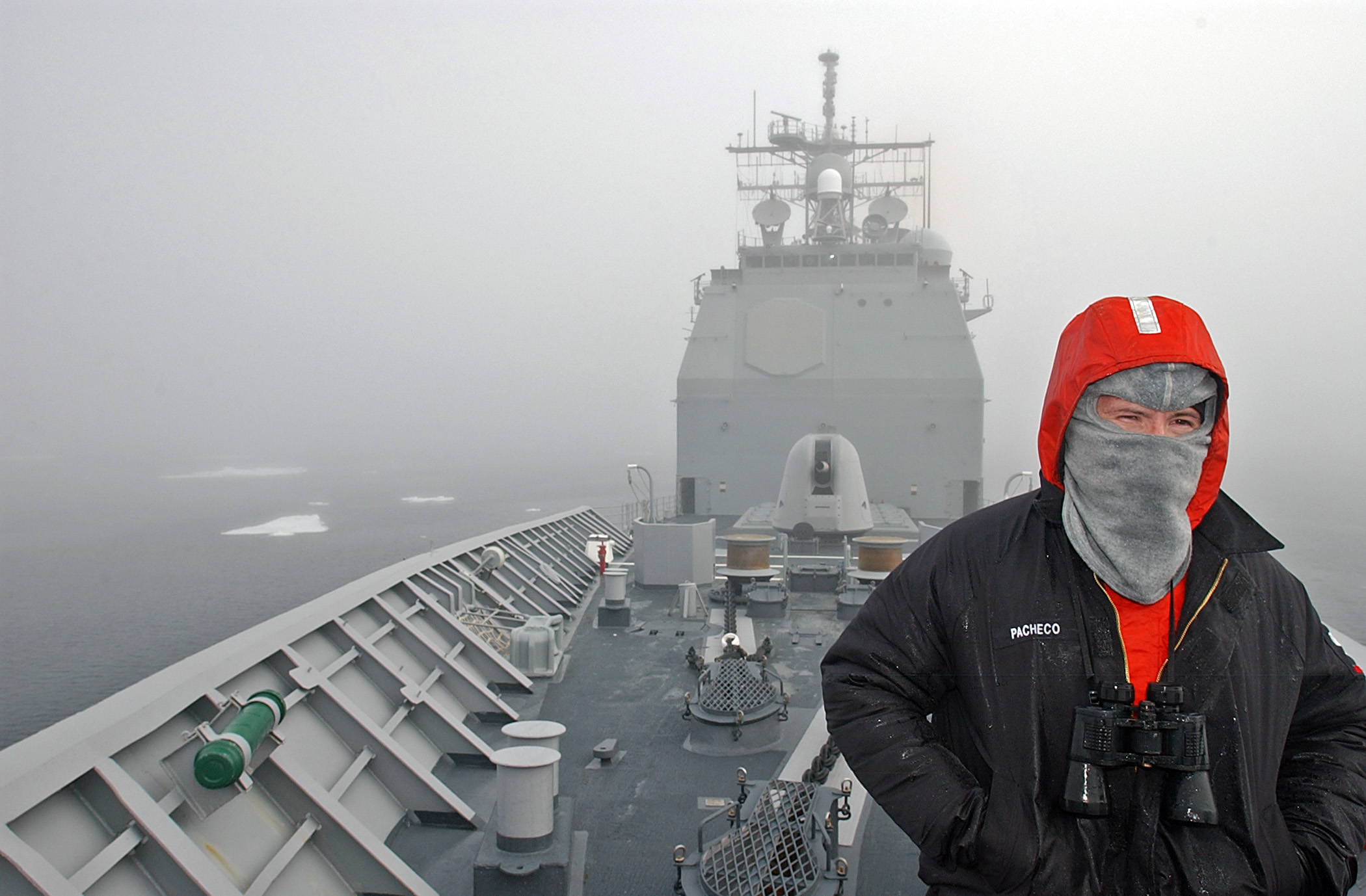 US_Navy_070612-N-5459S-049_Personnel_Specialist_3rd_Class_Wilbert_E._Pacheco,_a_Sailor_assigned_to_guided-missile_cruiser_USS_Normandy_(CG_60),_stands_a_low_visibility_lookout_on_the_forecastle_in_the_Arctic_Ocean.jpg
