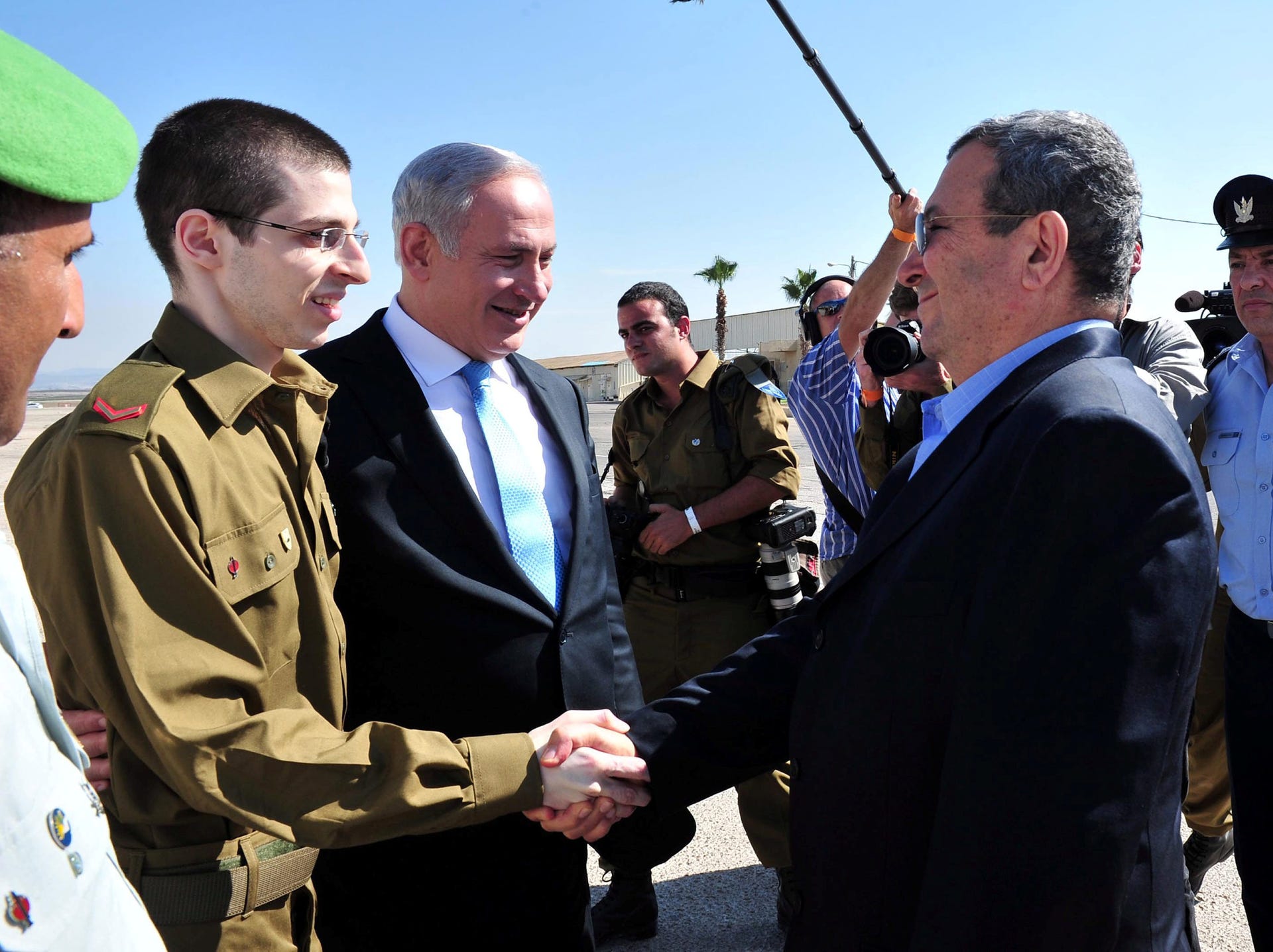 Then-Defense Minister Ehud Barak greeting Gilad Shalit in October 2011, with then-Prime Minister Benjamin Netanyahu alongside the just-released Israeli soldier. 