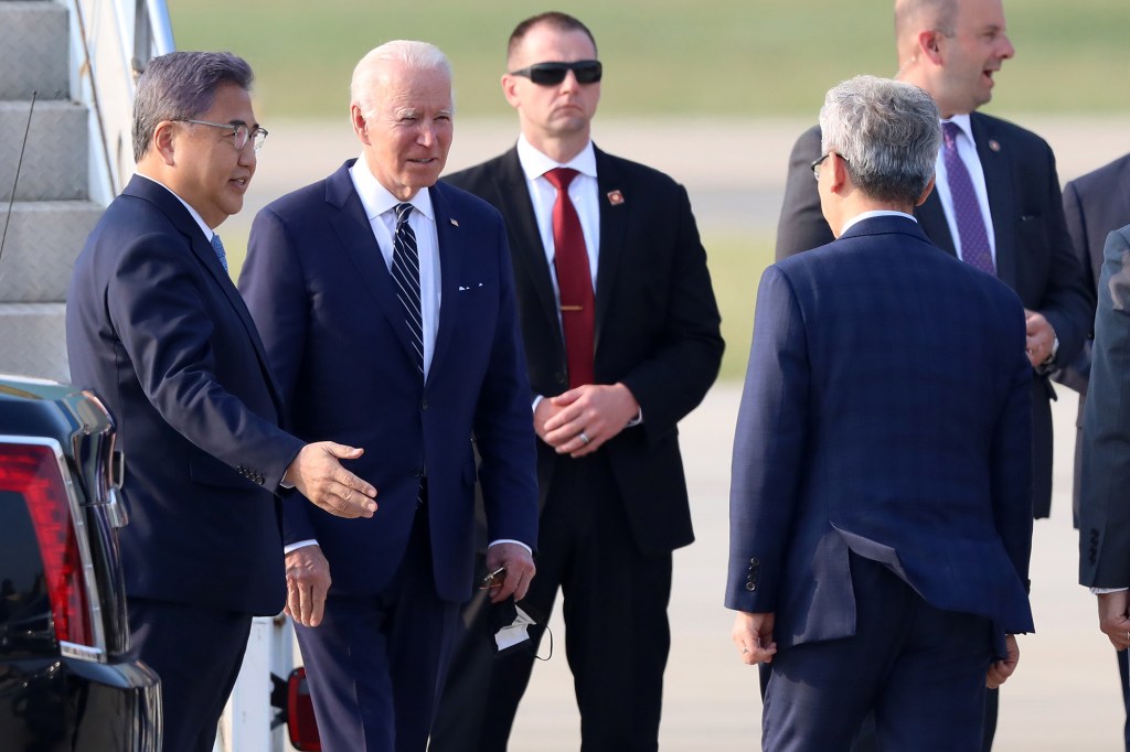 Biden is flanked by Secret Service agents while greeting South Korean Foreign Minister Park Jin.