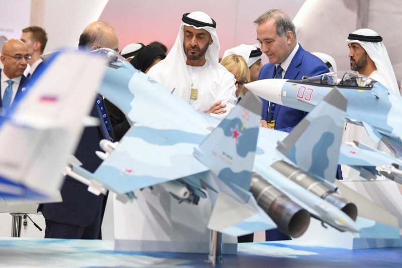 Abu Dhabi Crown Prince Sheikh Mohammed bin Zayed Al-Nahyan (C) listens to a representative at the Russian pavilion during a visit to the Dubai Airshow on Nov. 17, 2019.
