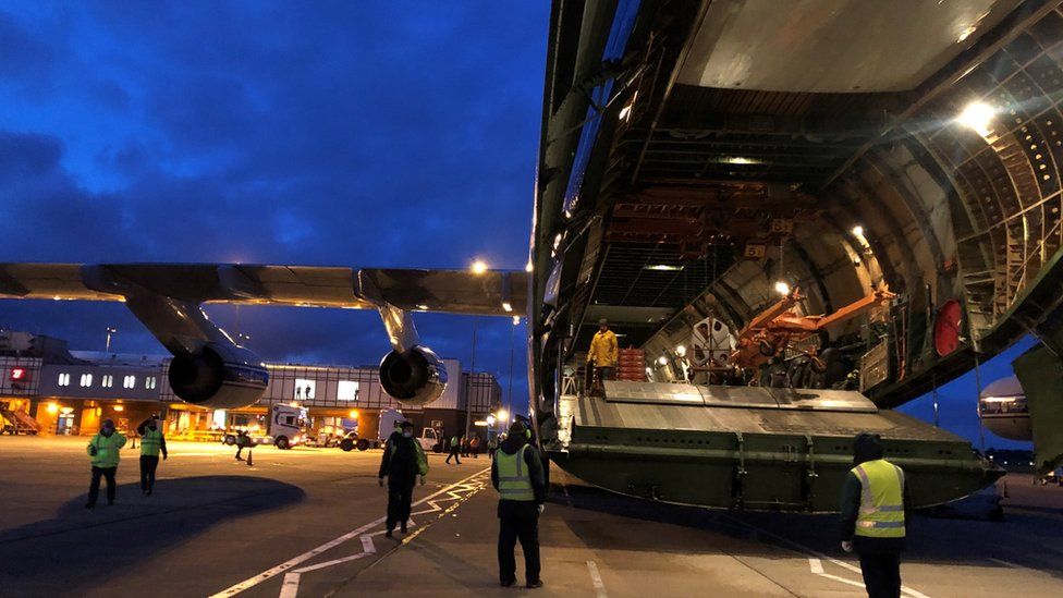 Medical equipment is loaded through the tail of the plane