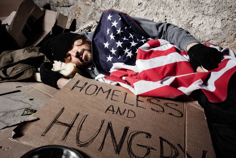 homeless-man-sleeping-outsie-under-american-flag-homeless-man-covered-american-flag-sleeping-street-next-to-139319573.jpg