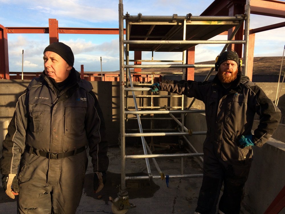 In this Monday, Oct. 31, 2016 photo construction workers at the site of the Aurora Observatory in Karholl, northern Iceland. Construction workers are building a research facility to study the Northern Lights, whose spectacular streaks of color light up Iceland’s winter skies. Funded by China's Polar Research Institute, the facility will house Chinese, Icelandic and international scientists when it opens next year. (AP Photo/Dorothee Thiesing)