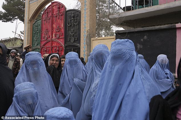 Hundreds of Afghans gather in front of the governors office to requests humanitarian aid, in Qala-e-Naw, Afghanistan, Tuesday, Dec. 14, 2021