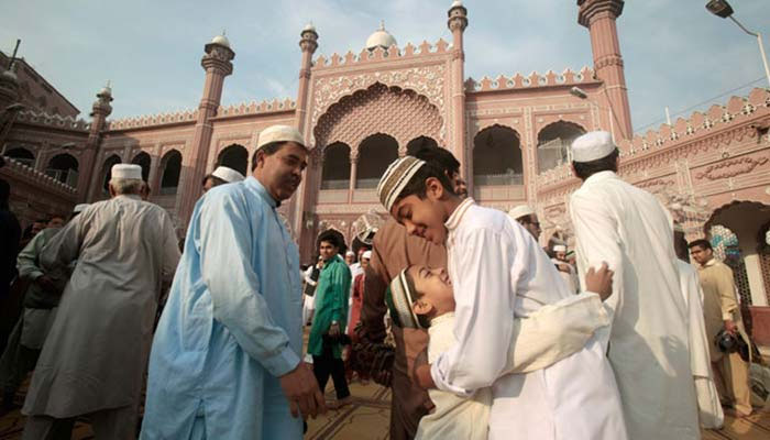 A representational image of people embracing each other on the festive occasion of Eid. — AFP/File