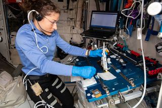 NASA astronaut Christina Koch working on the Genes In Space-6 experiment on the International Space Station.