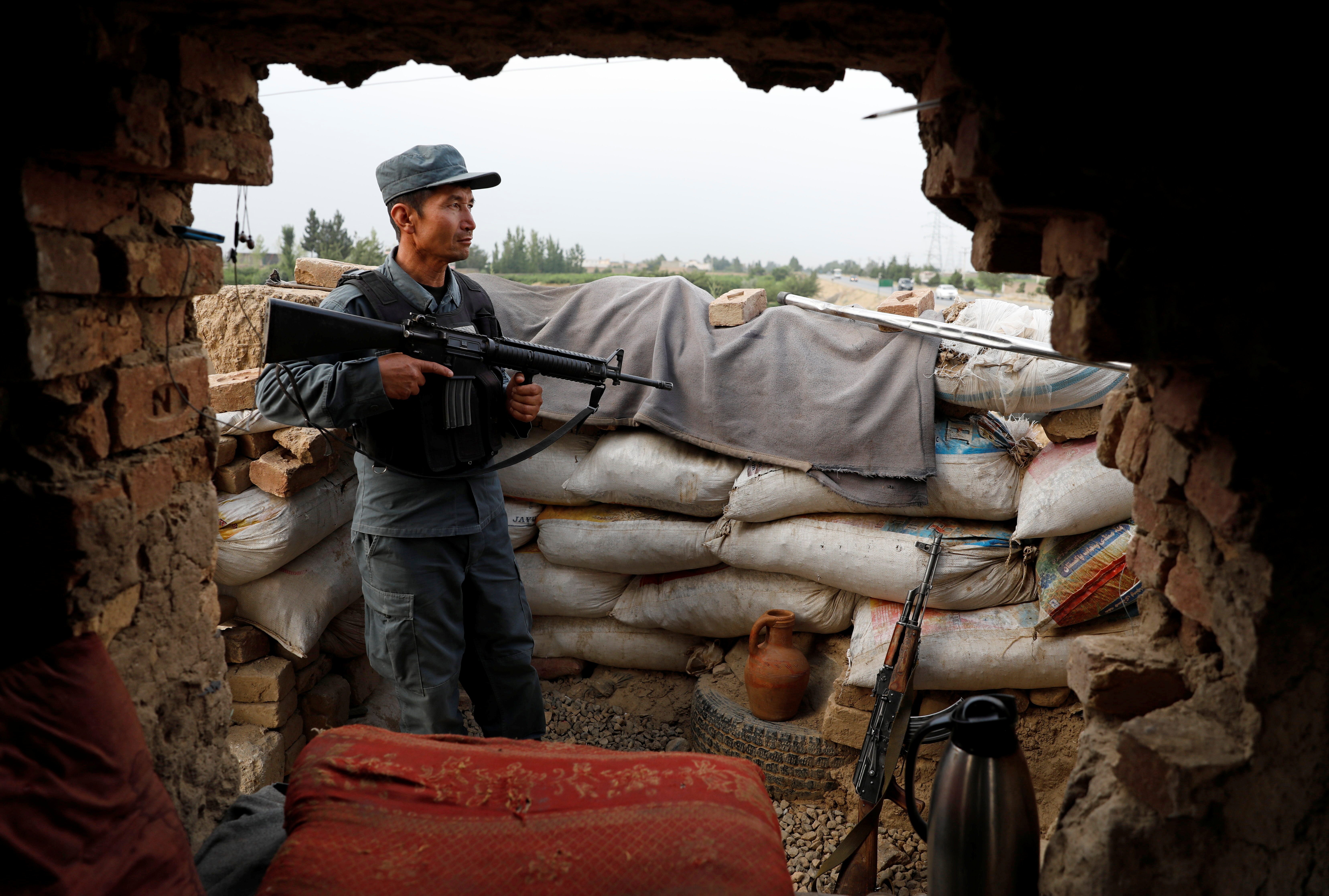 An Afghan policeman keeps watch at the check post on the outskirts of Kabul, Afghanistan July 13, 2021. REUTERS/Mohammad Ismail