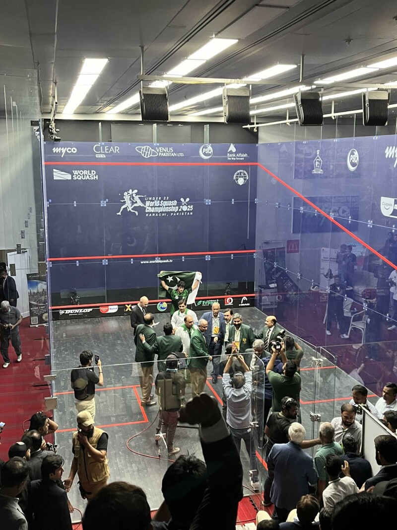 Noor’s teammates and coaches enter the glass court to congratulate Noor after he defeated Egypt’s El Torkey in the men’s final of the U-23 World Squash Championship in Karachi. — Photo by author