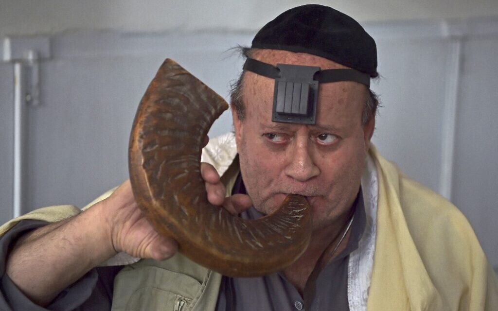 Afghan Jew Zebulon Simentov blows a 'Shofar' horn at a synagogue, housed in an old building in Kabul,  April 5, 2021. (WAKIL KOHSAR / AFP)