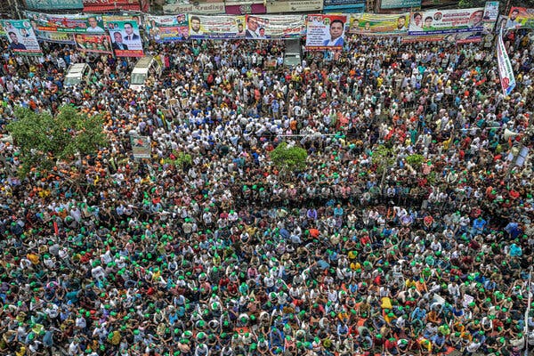 An overhead shot of thousands of people packed closely together at a political rally.