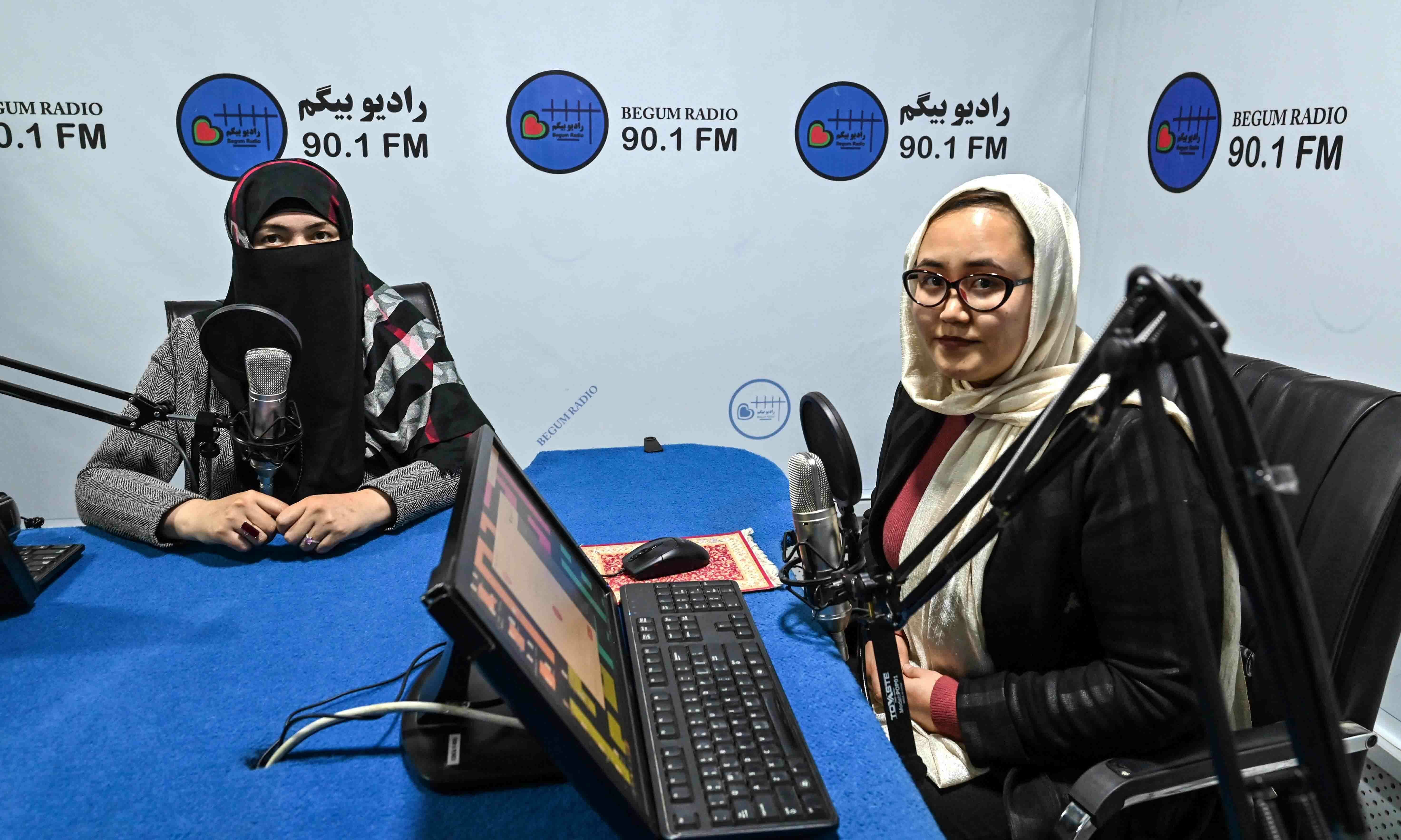 This picture taken on November 28 shows station director Saba Chaman (R) and her colleague working in a studio at Radio Begum in Kabul. — AFP