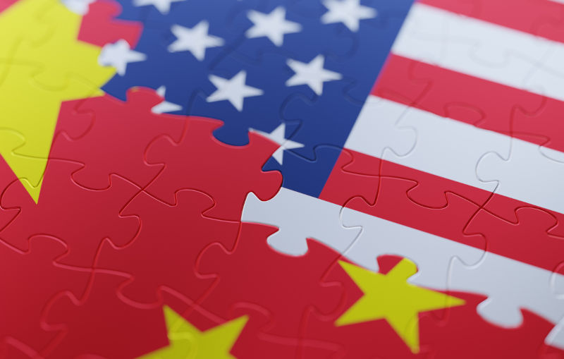 American and Chinese flag puzzle. Horizontal composition with copy space and selective focus.
