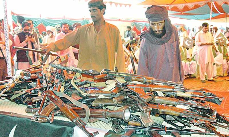 Militants surrender their weapons at a ceremony held in connection with Independence Day at the Police Lines in Quetta in this file photo. — APP