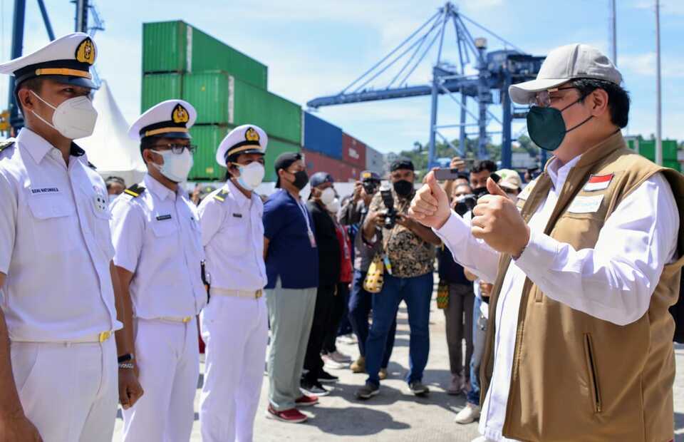 Coordinating Minister for the Economy Airlangga Hartarto, right, greets crew members of MV Tidar at Jayaoura Port, Papua on September 4, 2021. The ferry is converted into as a makeshift isolation facility for Covid-19 patients in the provincial capital.