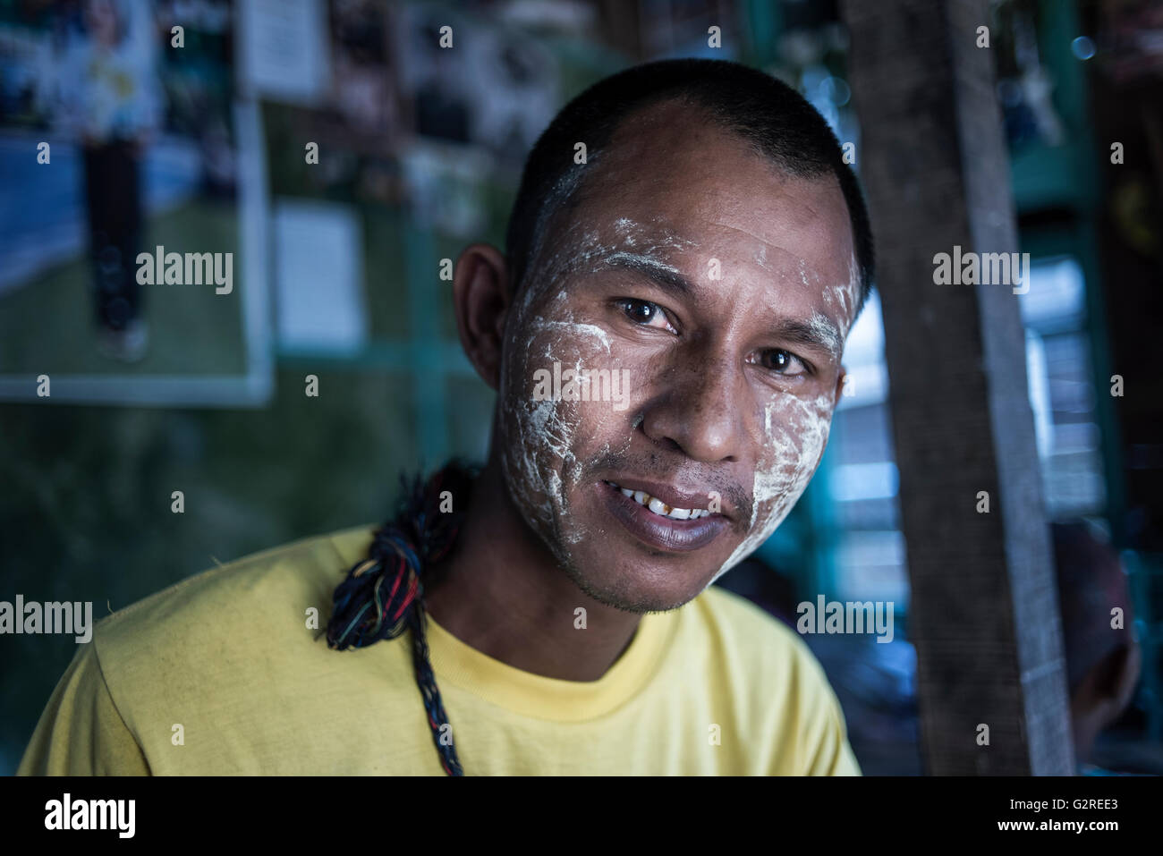 portrait-of-a-burmese-man-wearing-traditional-make-up-thanakha-on-G2REE3.jpg