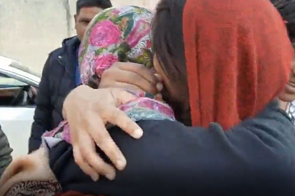 Farah hugs her sister outside court