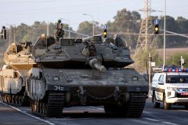 Israeli tanks seen on a road near Israel's border with the Gaza Strip in southern Israel October 20 [Violeta Santos Moura/Reuters]