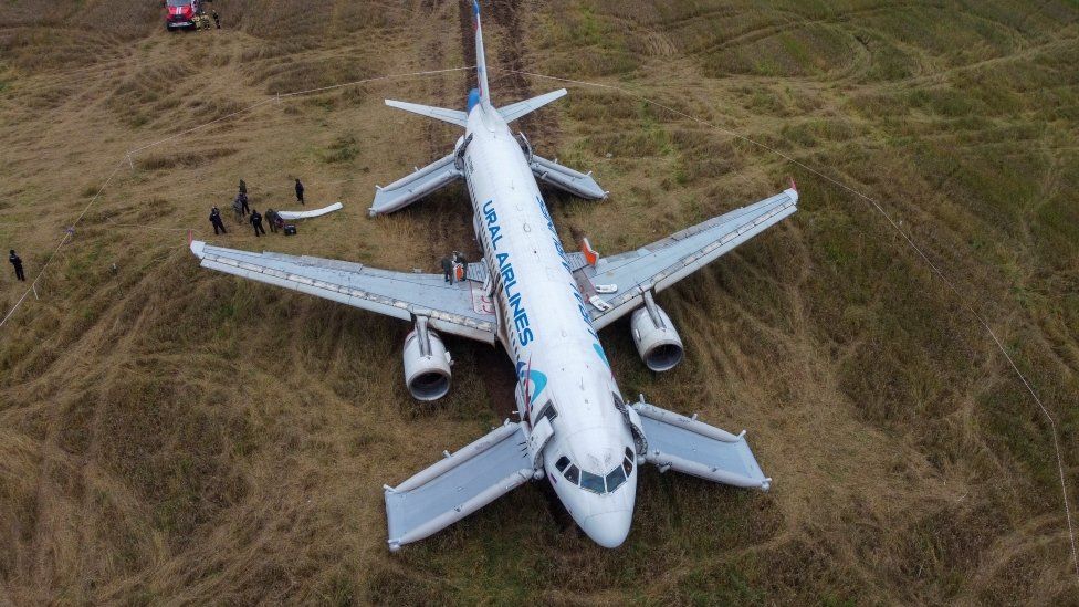 Ural Airlines plane with emergency slides deployed in Siberian field