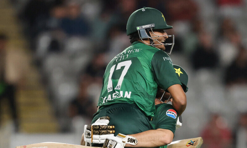 Pakistan’s Hasan Nawaz (L) celebrates scoring a century with teammate Salman Agha during the third T20 international cricket match between New Zealand and Pakistan at Eden Park in Auckland on March 21. — AFP