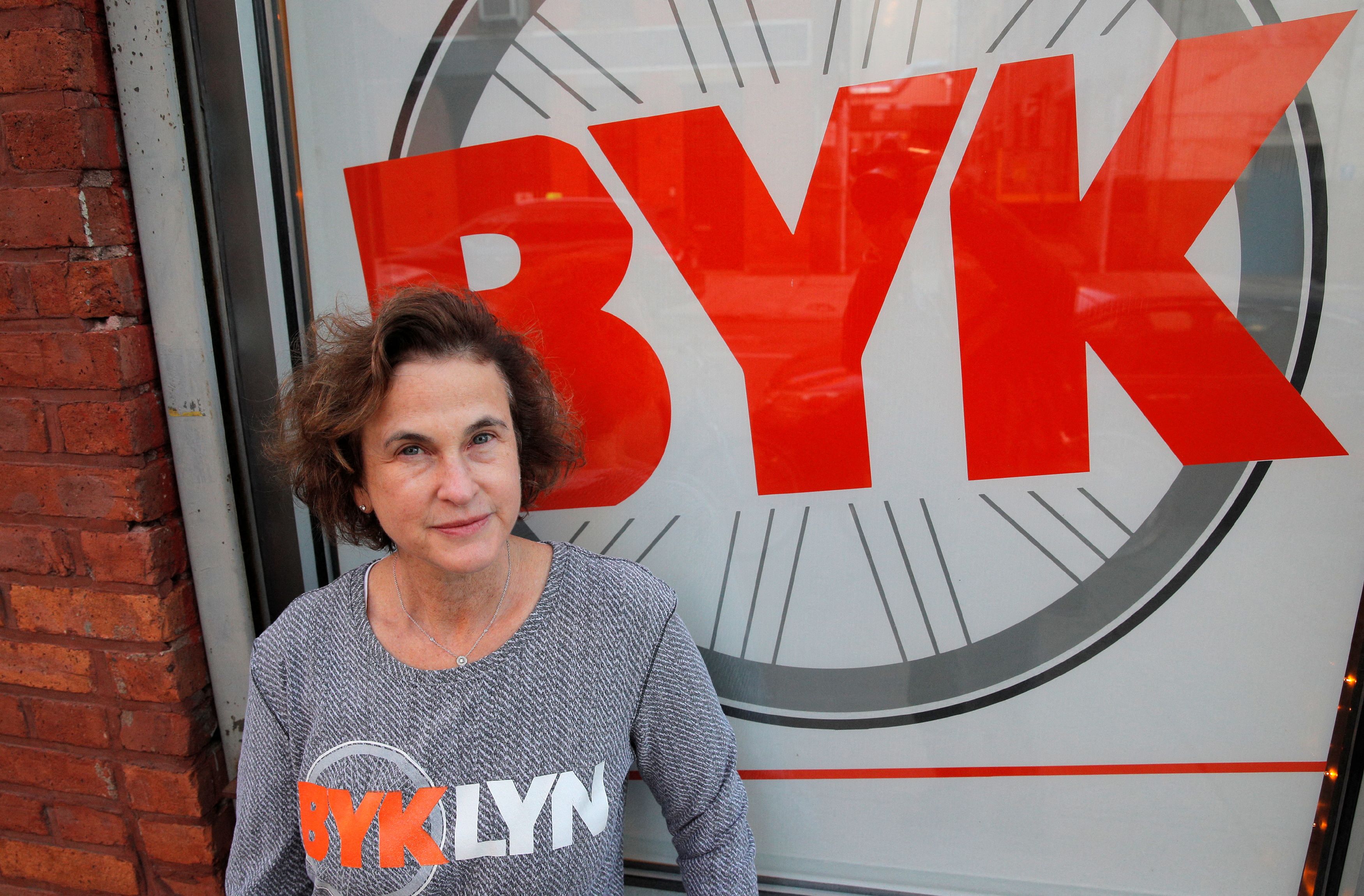 Amy Glosser poses outside her cycling studio, BYKlyn, in Brooklyn, New York, U.S., January 14, 2022. Picture taken January 14, 2022.REUTERS/Brendan McDermid