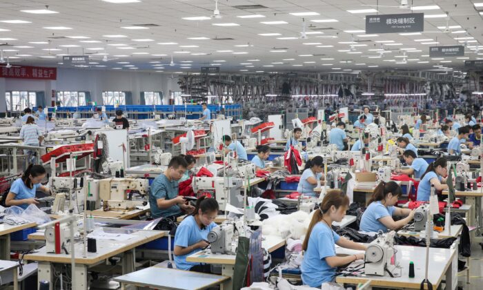 Employees produce down coats at a factory for Chinese clothing company Bosideng in Nantong in China's eastern Jiangsu province on Sept. 24, 2019. (STR/AFP via Getty Images)