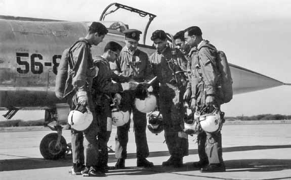 Flt-Lt-Alauddin-Ahmed-2nd-from-left-briefing-a-group-of-fighter-pilots-moments-before-proceeding-on-a-training-mission-on-Star-Fighter-FearlessWarriors.PK_.jpg
