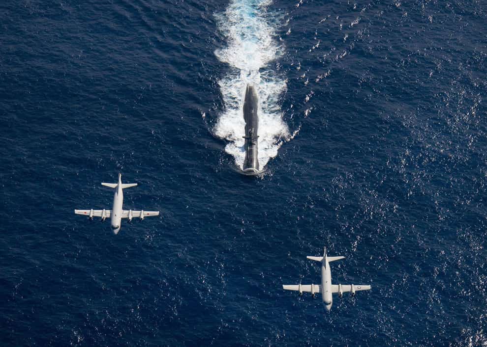 Two-P-3-Orion-anti-submarine-and-maritime-surveillance-aircraft-from-the-Japan-Maritime-Defense-Force-left-and-the-U.S.-Navy-right-fly-over-the-Los-Angeles-class-attack-submarine-USS-Houston.jpg