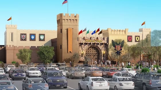 The outside of the Medieval Times in Scottsdale with the parking lot in the foreground