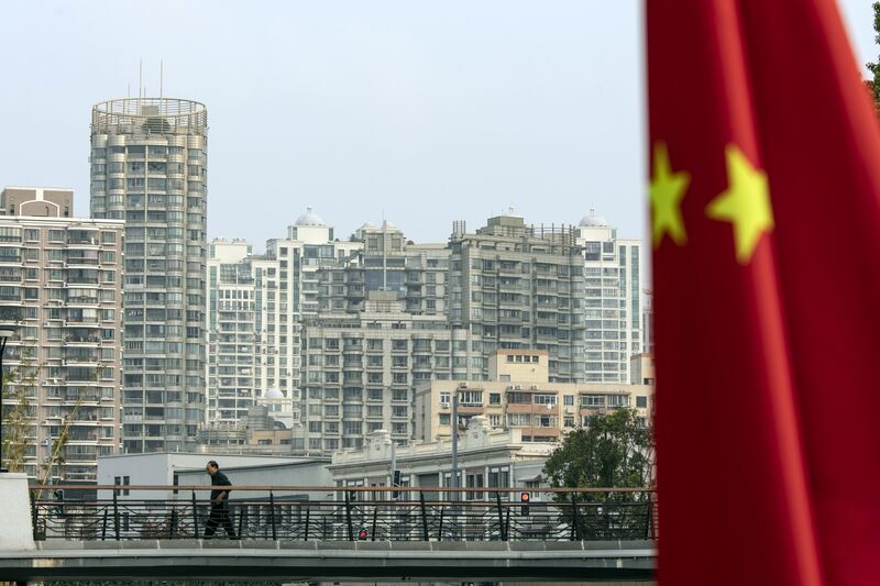 A Chinese flag in front of residential buildings in Shanghai, China. 