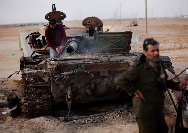 Libyan_rebel_cut_metal_from_destroyed_tank_to_be_used_as_armour_for_light_rebel_vehicles_for_combat_001.jpg