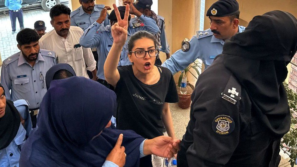 Police officials present arrested lawyer and human rights activist Imaan Mazari-Hazir (C) before a court in Islamabad on August 20, 2023.