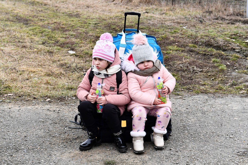 Sisters wait at a checkpoint run by local volunteers after arriving from Ukraine, crossing the border in Beregsurany, Hungary.