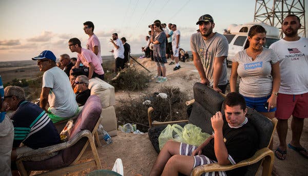 Israelis gathered on a hilltop outside the town of Sderot on Monday to watch the bombardment of Gaza.