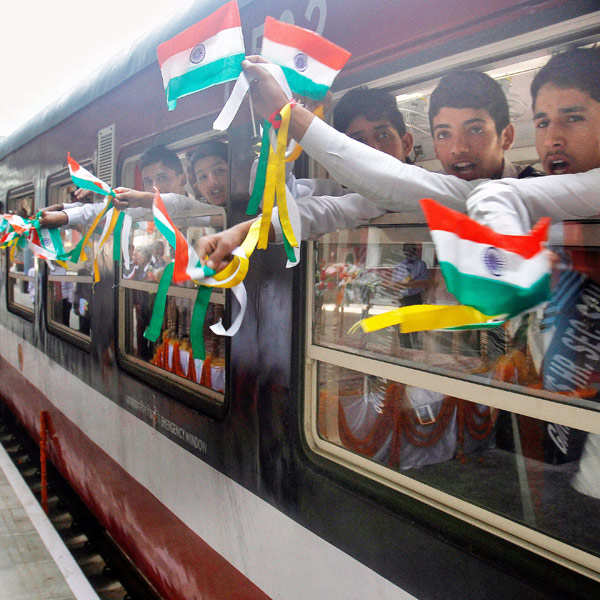 Young-Indian-school-children-displaythe-national-flag-as-they-wave-from-inside-the-first-train-connecting-Qazigund-to-Banihal-during-its-inauguration-in-Banihal-some-120-kilometers-75-miles-south-of-Srinagar-India-Wednesday-June-26-2013-.jpg