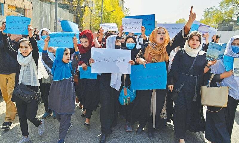 In this file photo, Afghan women and girls stage protest in front of the Ministry of Education in Kabul on March 26, 2022, demanding that high schools be reopened for girls. —AFP