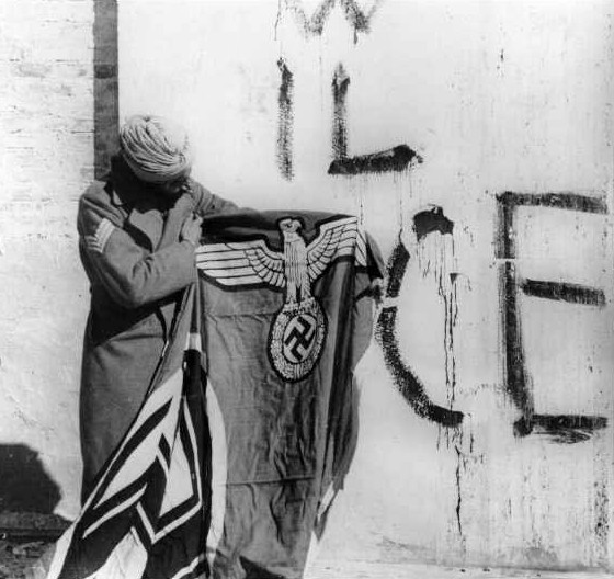 Sikh_soldier_with_captured_Swastika_flag.jpg