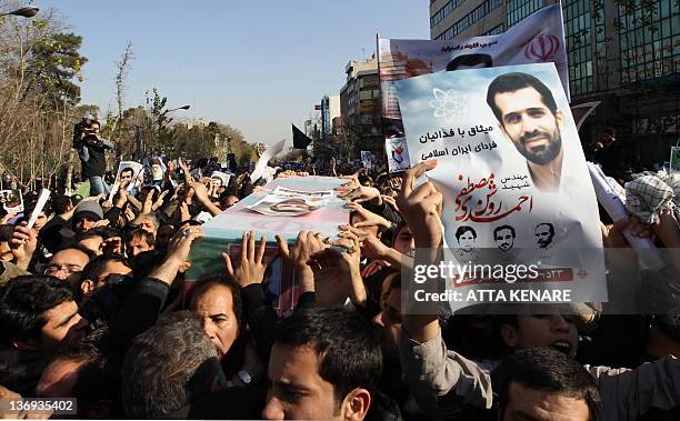 mourners-carry-the-coffin-of-iranian-nuclear-scientist-mostafa-ahmadi-roshan-during-his.jpg