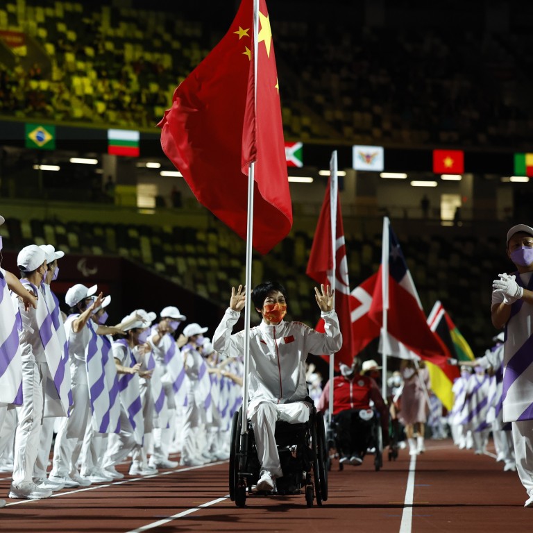 China’s Zhang Xuemei carries the national flag during the closing ceremony of the Tokyo 2020 Paralympic Games. Photo: Reuters