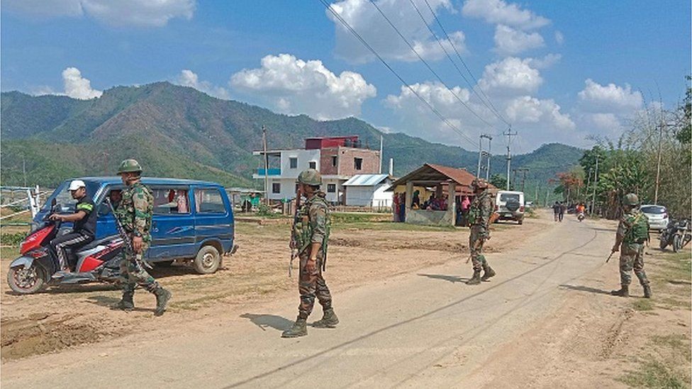 Indian army soldiers patrol along the violence hit area of Dolaithabi village in Manipur state on May 29, 2023.