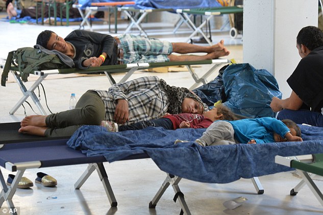 2C6C614F00000578-3249667-Refugees_rest_in_a_former_furniture_factory_after_crossing_the_b-a-109_1443223064354.jpg