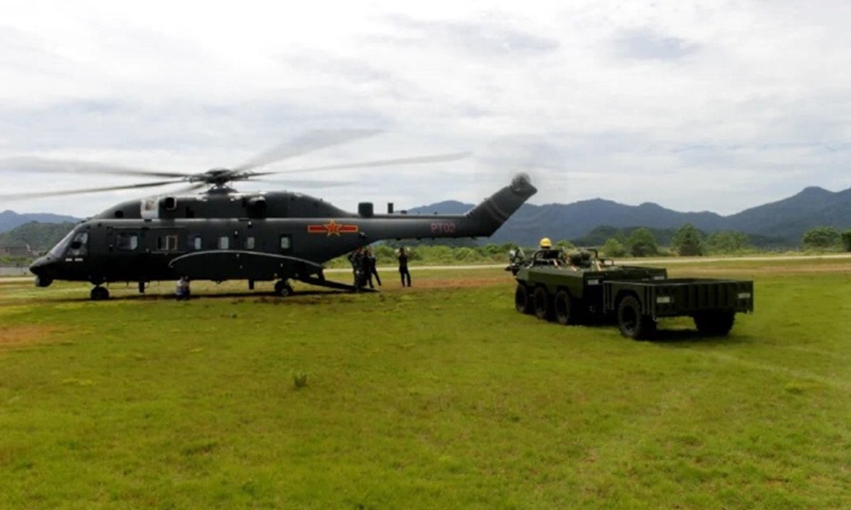 A Z-8L helicopter of the Chinese People's Liberation Army prepares to transport an all-terrain assault vehicle. Photo: Screenshot from China Central Television