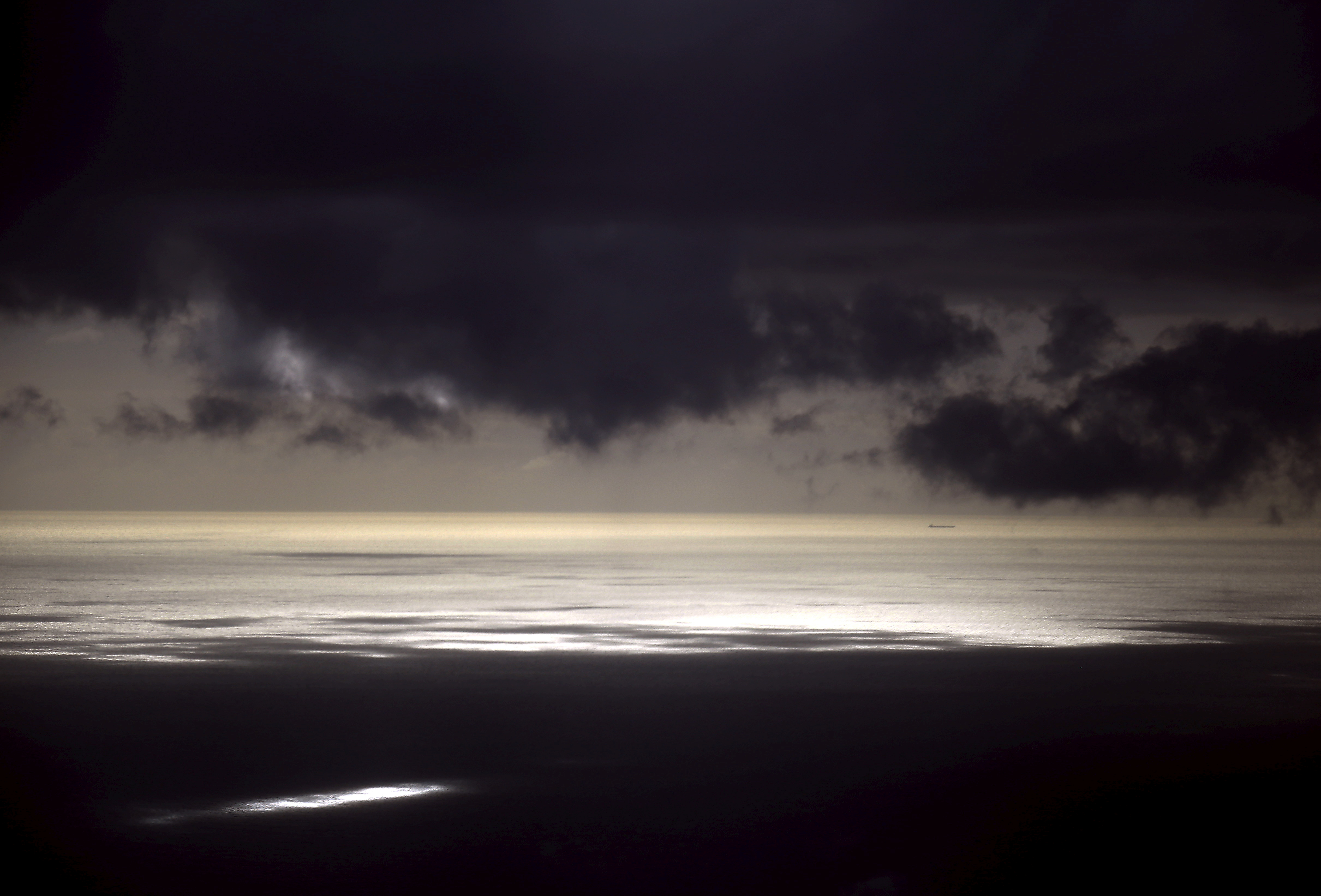 Storm clouds can be seen above a coal ship as it sails near Lady Elliot Island