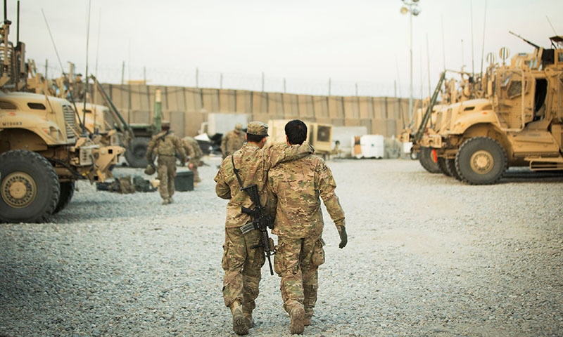 In this file photo, a United States soldier from the 3rd Cavalry Regiment walks with the unit's Afghan interpreter before a mission. — Reuters