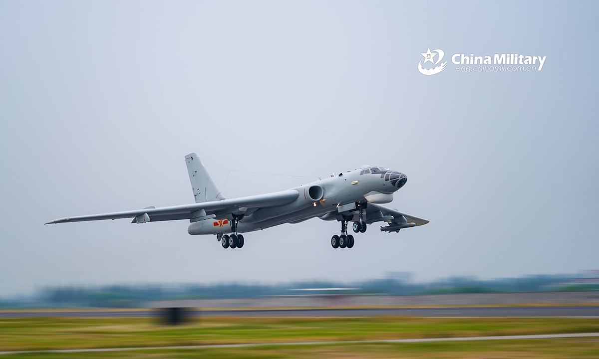 A bomber attached to an aviation regiment of the PLA Navy takes off for a realistic round-the-clock flight training exercise on August 9, 2021. The training contains multiple subjects such as shock tactics against ground and sea targets, flight-refueling operations and so on. (eng.chinamil.com.cn/Photo by Yang Ling)