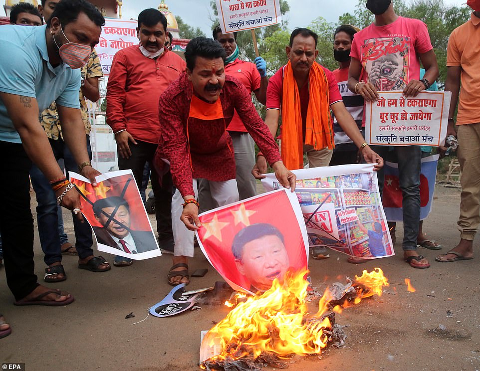 29677718-8430741-Indians_burn_images_of_Chinese_President_Xi_Jinping_in_Bhopal_to-a-37_1592391247492.jpg