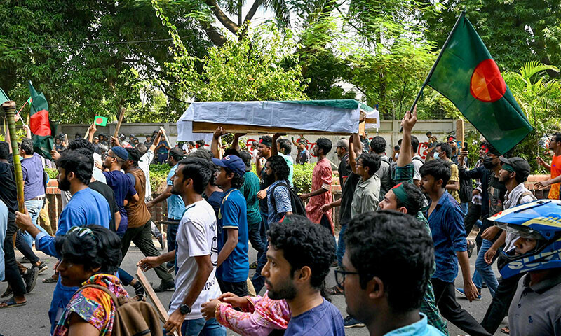 Students protesting against quotas in government jobs carry a symbolic coffin of victims, a day after they died in a clash with police personnel, during an absentee funeral prayer ceremony at Dhaka University in the capital on July 17, 2024. — AFP