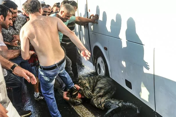 PAY-PEOPLE-PROD-People-kick-and-beat-a-Turkish-soldier-that-participated-in-the-attempted-coup.jpg