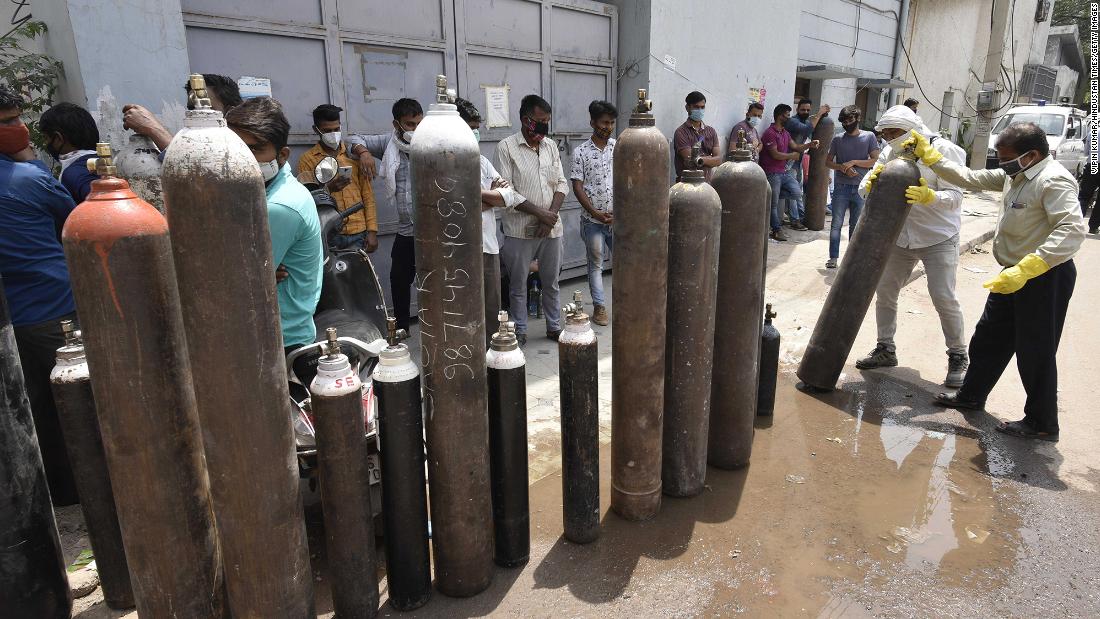 Family members of Covid-19 patients waiting to refill empty oxygen cylinders in Manesar, India. 