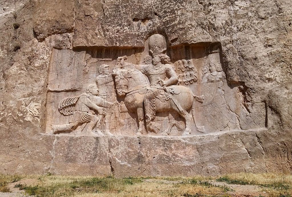 1024px-A_rock-face_relief_of_Shapur_I_over_the_Roman_Emperor_Valerian.jpg