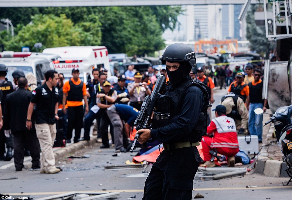30278A4900000578-3398712-An_Indonesian_policeman_stands_guard_in_front_of_a_blast_site_at-m-41_1452759088408.jpg